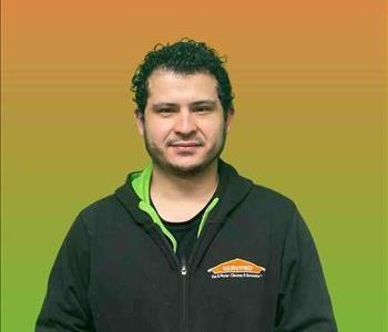 Man standing in front of green and orange background