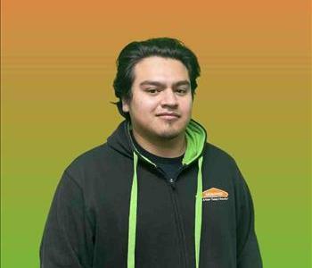 Man standing in front of green and orange background